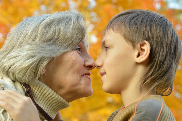 Portrait of a grandmother and grandson posing in park