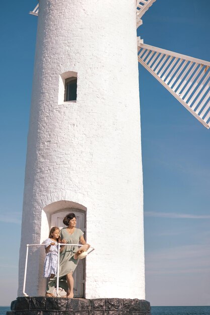 Portrait of Grandmother with her little granddaughter spent weekend and walking on sea coast