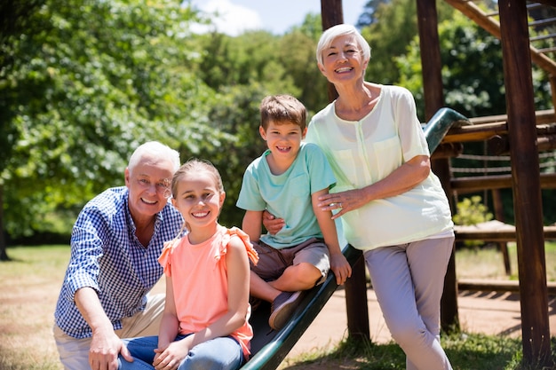 Portrait of grandparents playing with their grandchildren in park