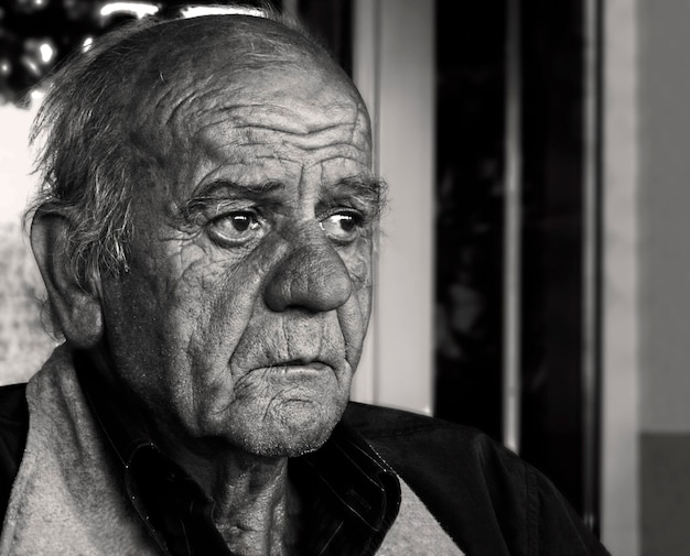 Portrait of a Greek elderly man with rich facial expression in black and white in Greece