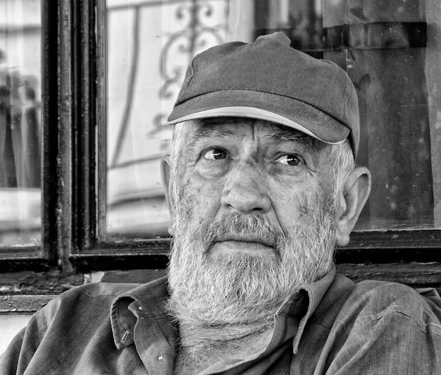 Portrait of a Greek elderly man with rich facial expression in black and white in Greece