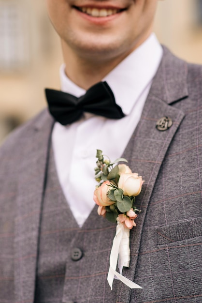 Portrait of the groom on the background of an old building