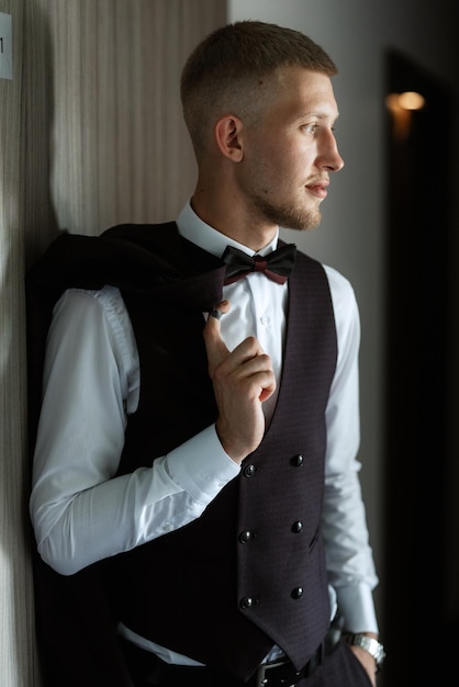 Portrait of the groom in a brown threepiece suit