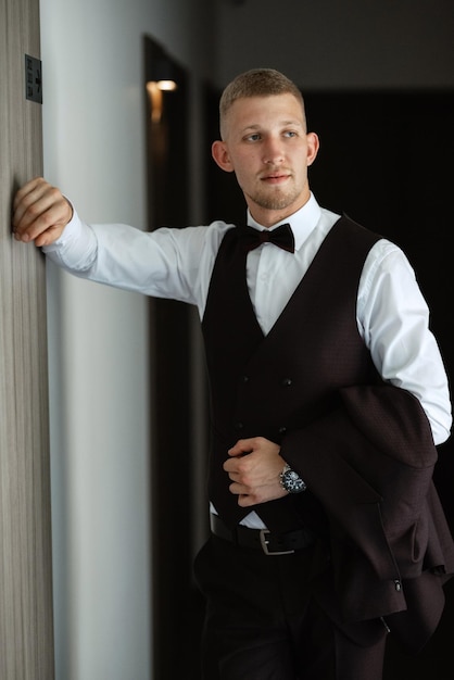 Portrait of the groom in a brown threepiece suit