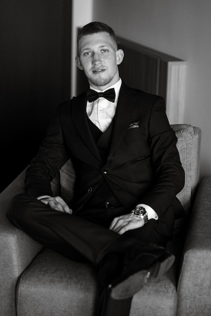 Portrait of the groom in a brown threepiece suit