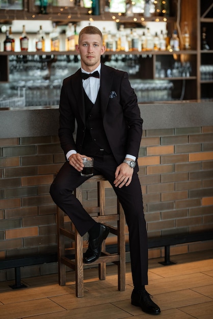 Portrait of the groom in a brown threepiece suit