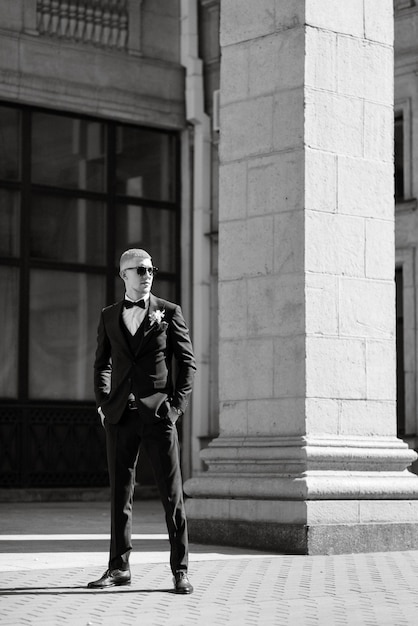 Portrait of the groom in a brown threepiece suit