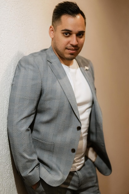 Portrait of the groom in a light gray suit