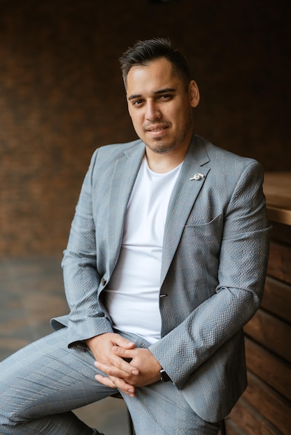 Portrait of the groom in a light gray suit