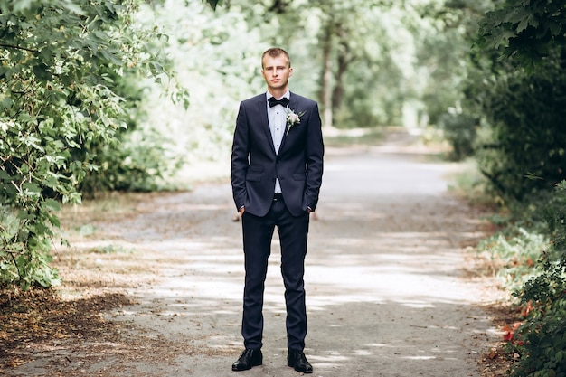 Portrait of a groom posing in nature