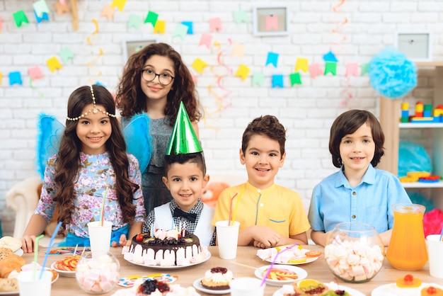 Portrait of group of joyful children at birthday party.