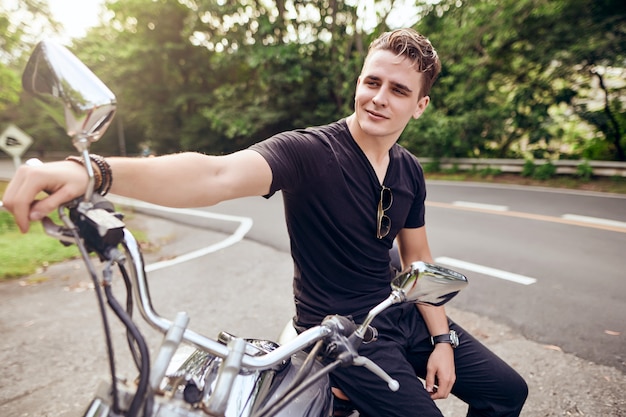 portrait of a guy sitting on a motorcycle