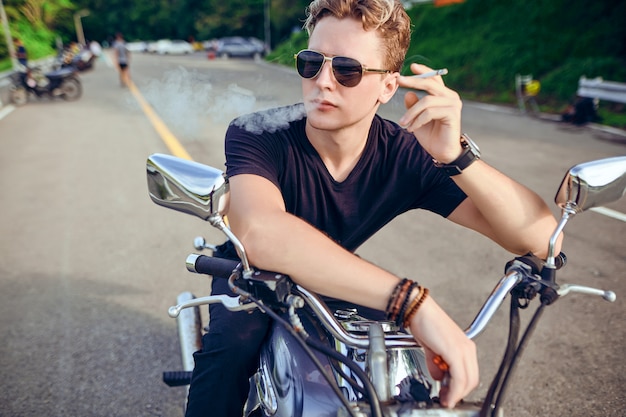 portrait of a guy sitting on a motorcycle