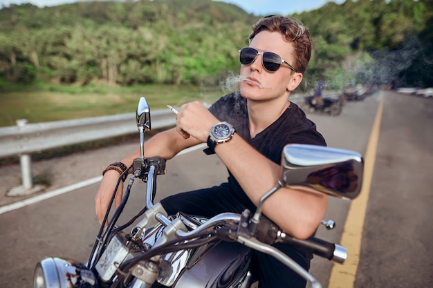 portrait of a guy sitting on a motorcycle