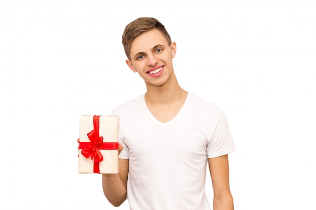 Portrait of a guy with a gift, isolate, the guy in a white T-shirt gives a gift