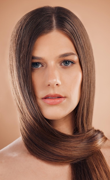 Portrait hair care or woman with cosmetics texture or natural beauty on brown studio background Female straight hair or organic growth for hairstyle keratin or hair dye advertising for marketing