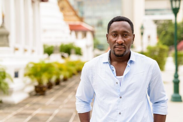 Portrait of handsome African businessman at Buddhist temple