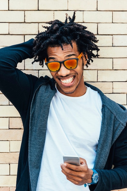 Portrait of handsome afro man in the street.