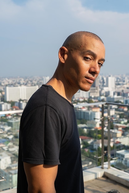 Portrait of handsome bald man wearing tshirt outdoors