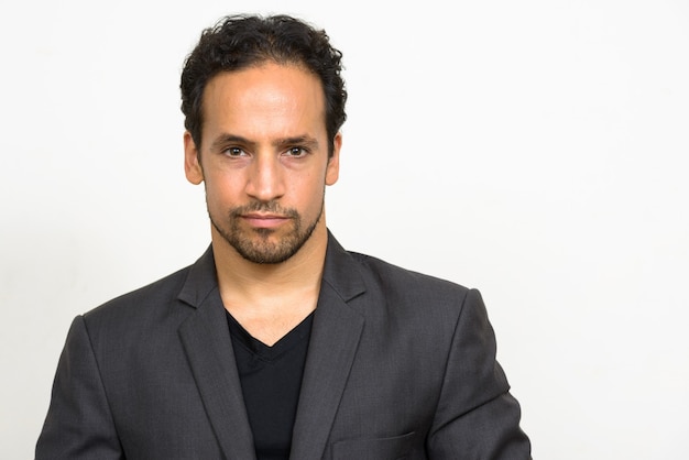 Portrait of handsome bearded Hispanic businessman in suit