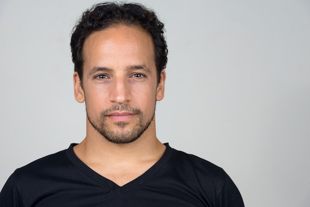 Portrait of handsome bearded Hispanic man with curly hair