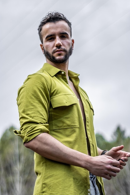 Portrait of handsome bearded man looking at camera outdoors Handsome young bearded man in casual clothes looking at camera outdoors