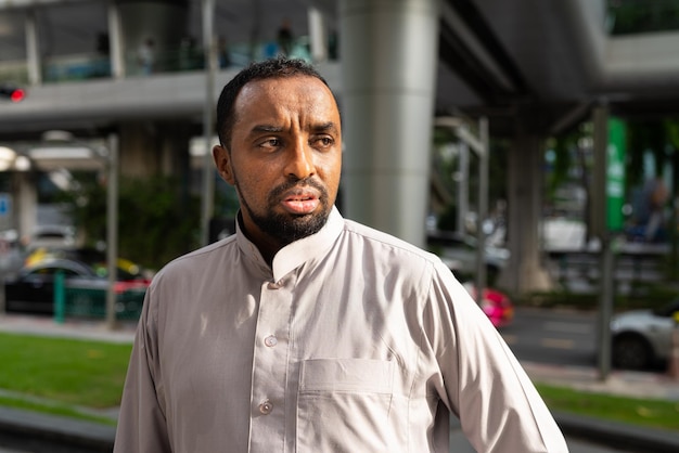 Portrait of handsome black businessman in city