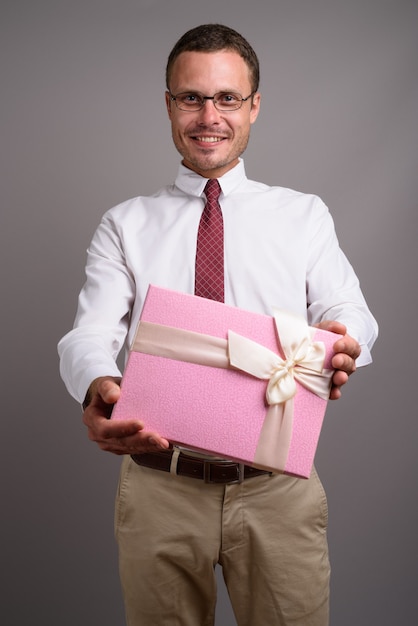 Portrait of handsome businessman on gray