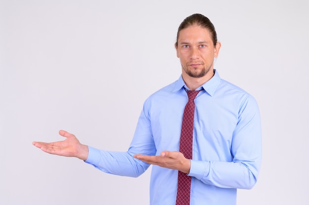 Portrait of handsome businessman showing something to the side