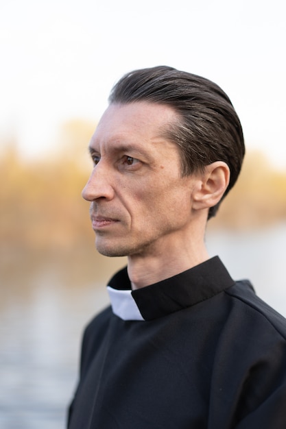 Portrait of handsome catholic priest or pastor with collar