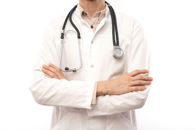 Portrait of handsome doctor in white medical coat with stethoscope on white background with copy space