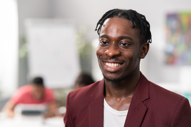 Portrait of a handsome elegant man with dreadlock looks into camera with brown eyes