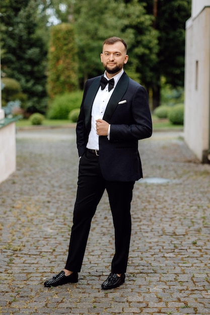 portrait of a handsome groom in a tuxedo