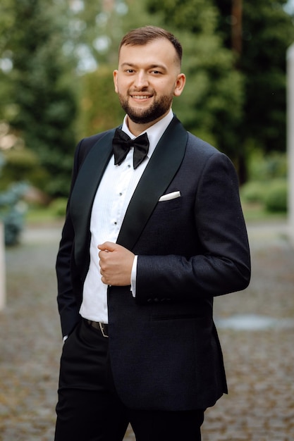 portrait of a handsome groom in a tuxedo