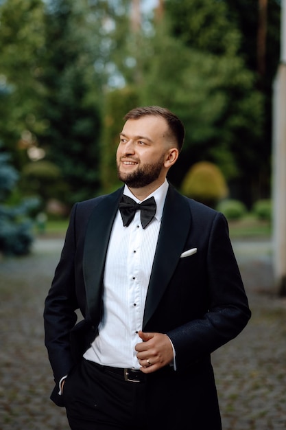 portrait of a handsome groom in a tuxedo