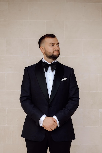 portrait of a handsome groom in a tuxedo