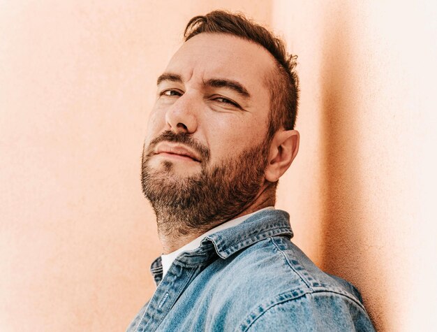 Portrait of a handsome hipster man in a jean jacket in a big city on the street a life style