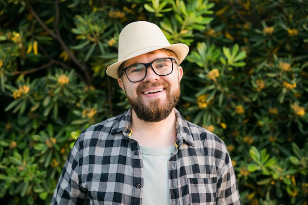 Portrait handsome laugh man over green bush outside  summer and emotional concept