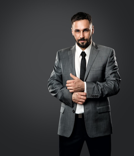 Portrait of Handsome Man in Gray Suit with Black Tie Elegant Stylish Bearded Businessmen over Dark