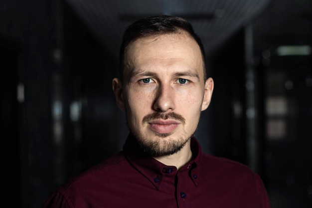 Portrait of a handsome man in an maroon shirt