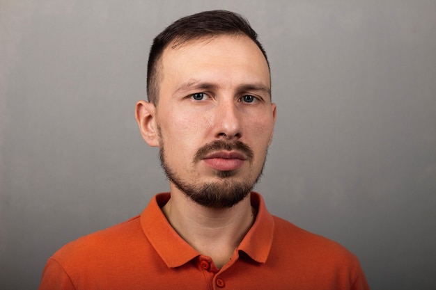 Portrait of a handsome man in an orange shirt