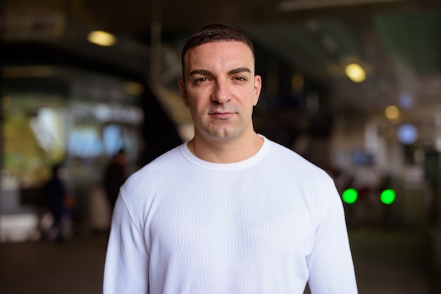 Portrait of handsome man at the sky train station in the city