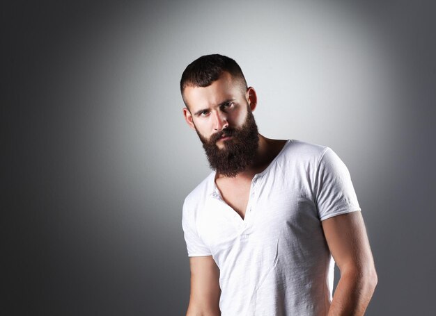 Portrait of handsome man standing isolated on grey background