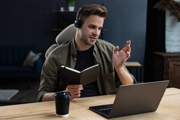 Portrait of handsome smiling young man studying online online education remote working home educatio