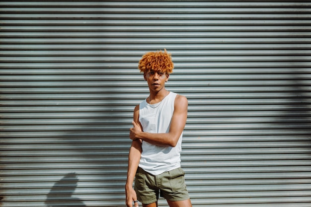 Portrait of handsome teen man with nice appearance and stylish makeup posing to the camera