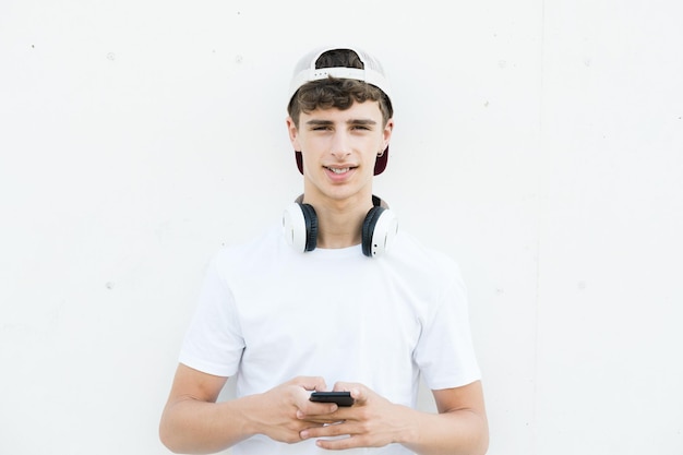 Portrait of handsome teenager boy using phone