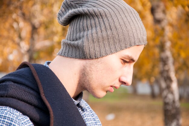 Portrait of handsome teenager with woolen hat in the park