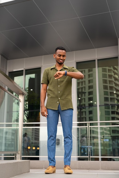 Portrait of handsome young black man outdoors in city