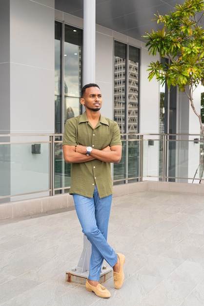 Portrait of handsome young black man outdoors in city