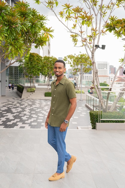 Portrait of handsome young black man outdoors in city